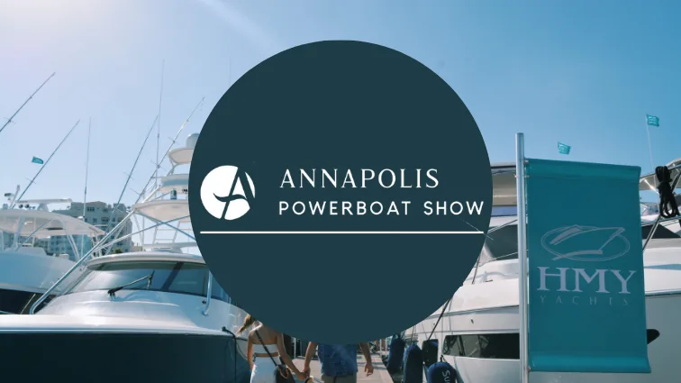 Annapolis Powerboat Show cover graphic with yachts along the docks and an HMY Yacht Sales flag.