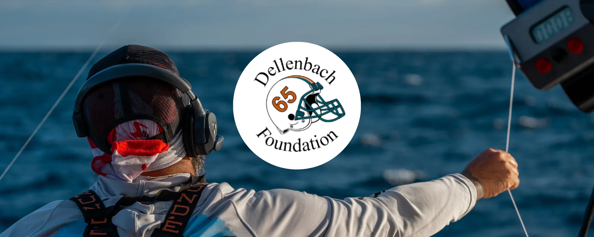 Angler in a fighting harness working a rod aboard a sportfish boat, with the Dellenbach Foundation 65 logo.