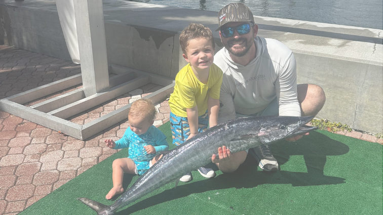 fishing participants holding up their wahoo for a picture