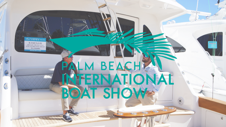 two sales specialists talking on the back of a sportfish yacht at the palm beach international boat show