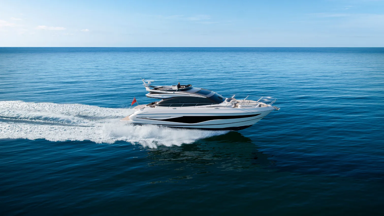 Princess S65 Sportbridge yacht running at speed across open blue water, full profile with a white wake.