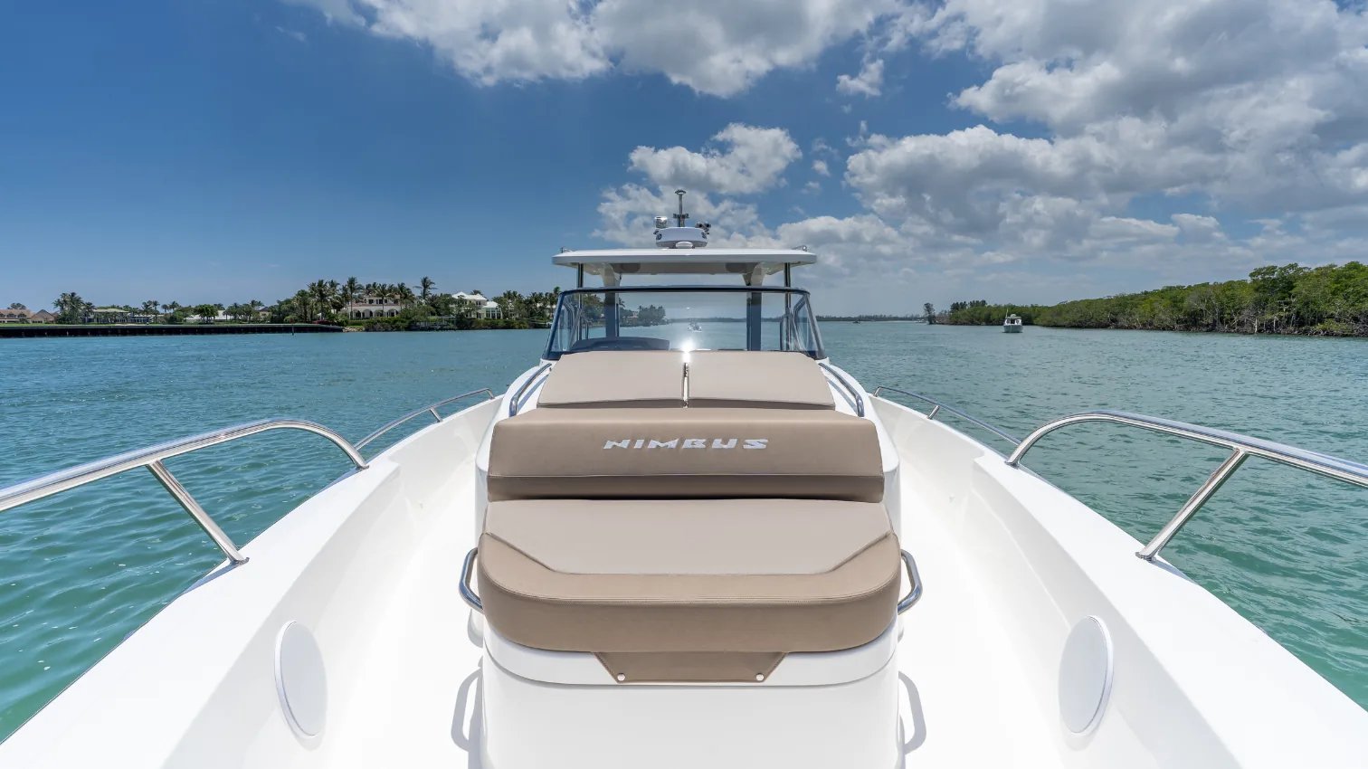 Nimbus T11 bow with forward sun-lounge seating, viewed from the foredeck.