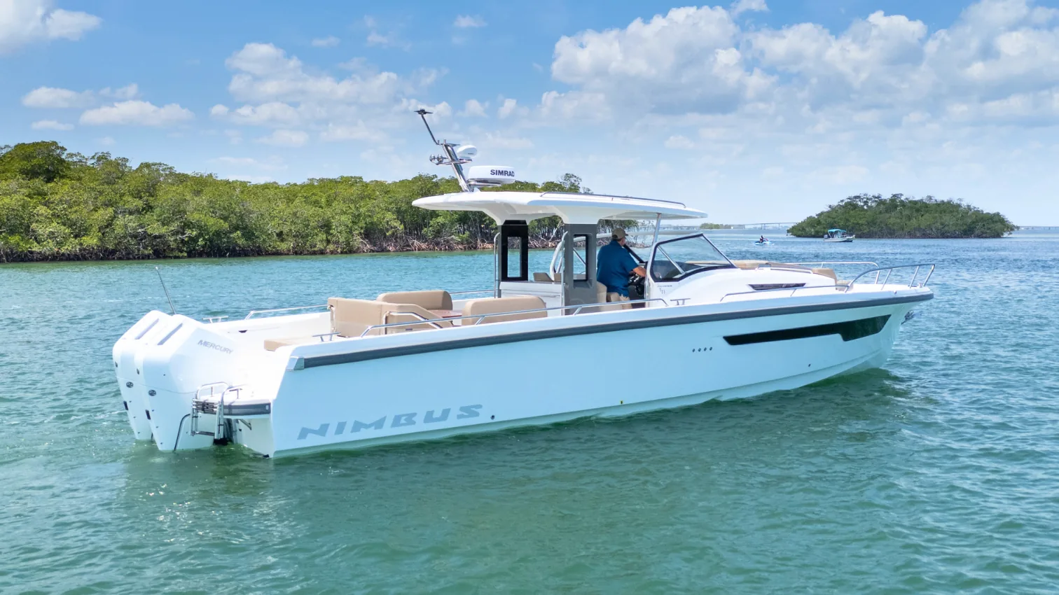 The Nimbus T11 outboard day boat at anchor near mangroves, full profile view.