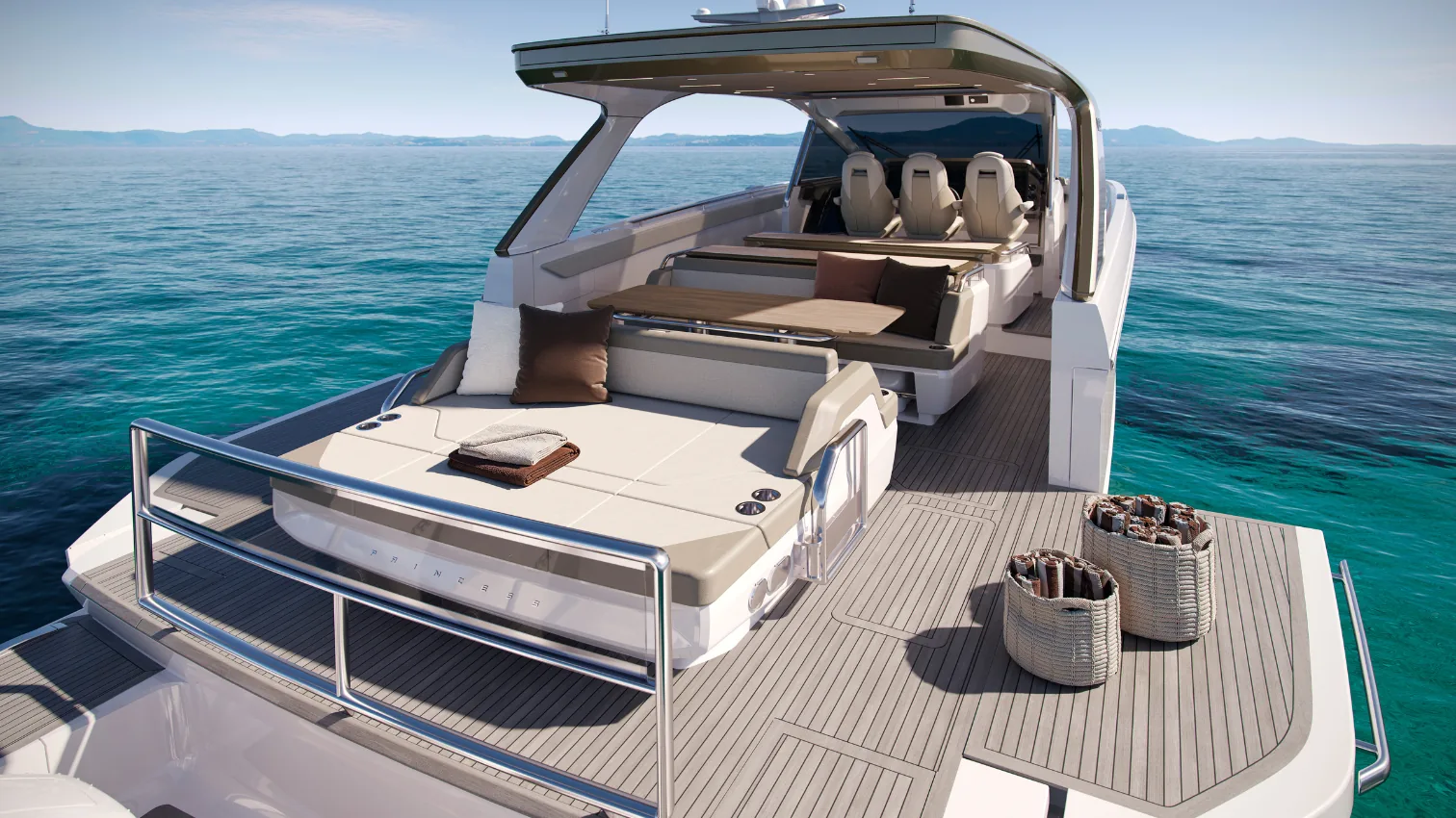Princess C48 Open aft cockpit with sunpad, helm seating, and teak swim platform set up for entertaining.