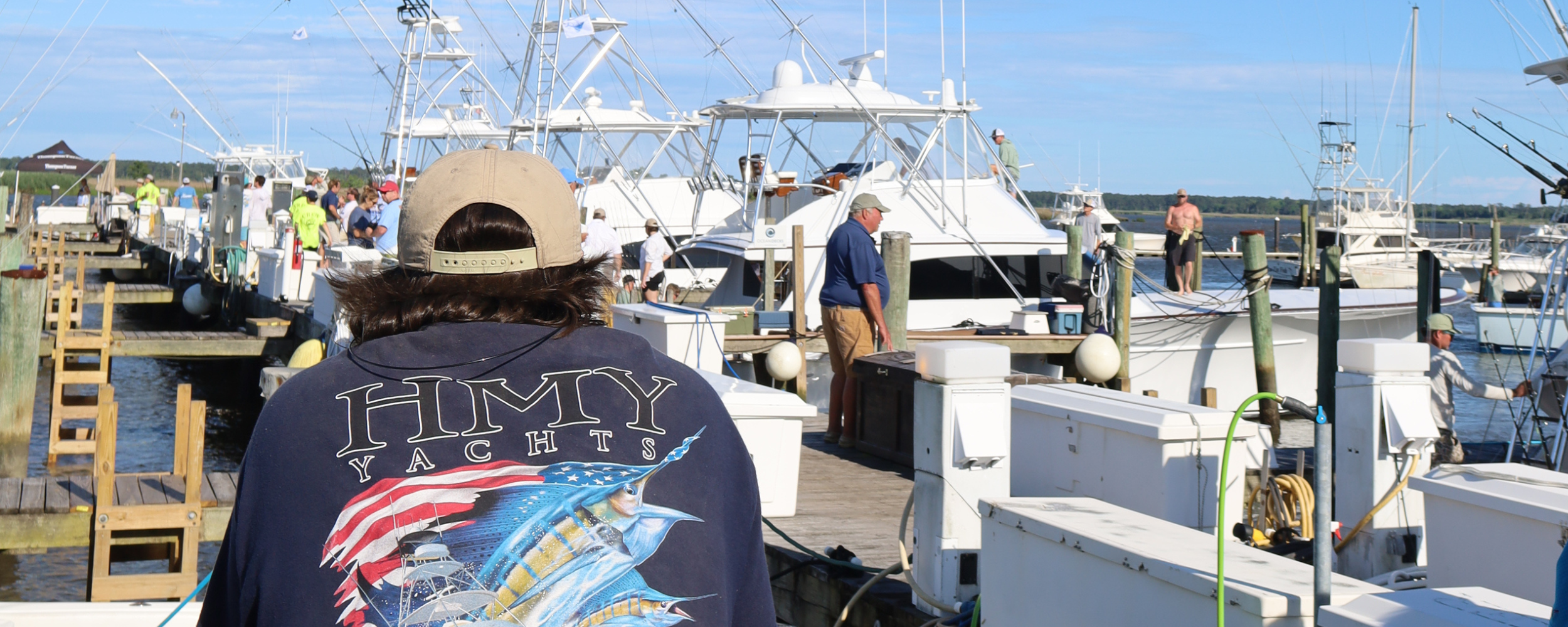 a look out at the docks with a viewer in an hmy yachts shirt