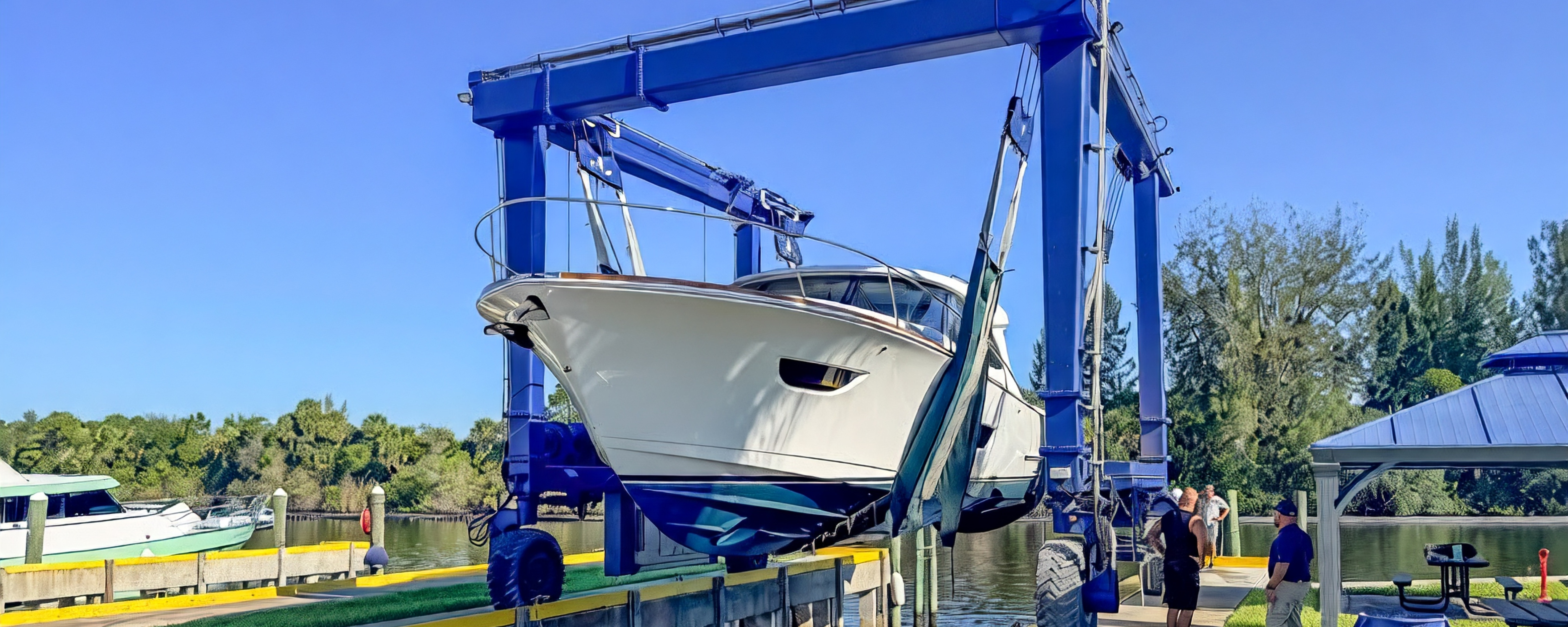 ECLIPSE 505 Shadow being hauled out at a marina in a travel lift.